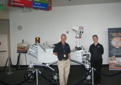 Dave Martin and Diane Pugel posing with the Curiosity rover model.