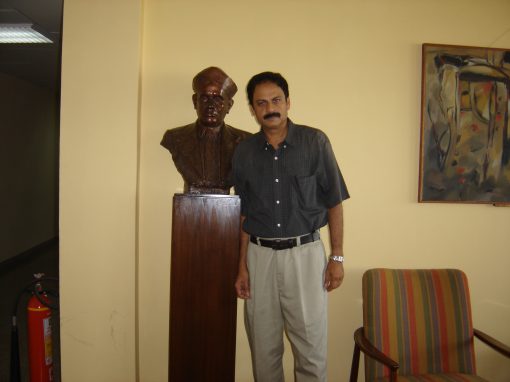 Professor Misra with a bust of Sir C.V. Raman in the 4th floor hallway of TIFR, Mumbai, India